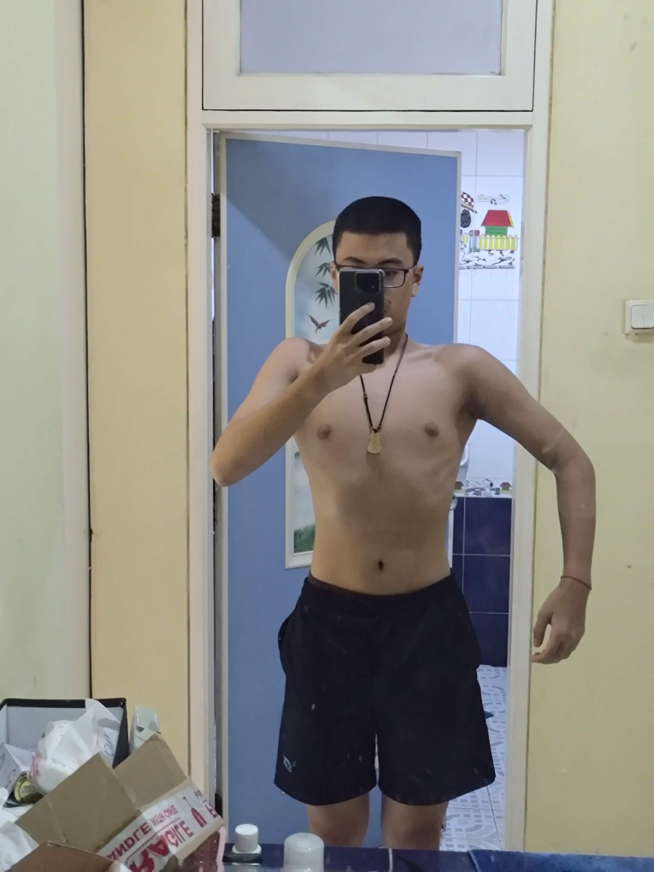 Alvino taking a mirror selfie after losing weight in 2024