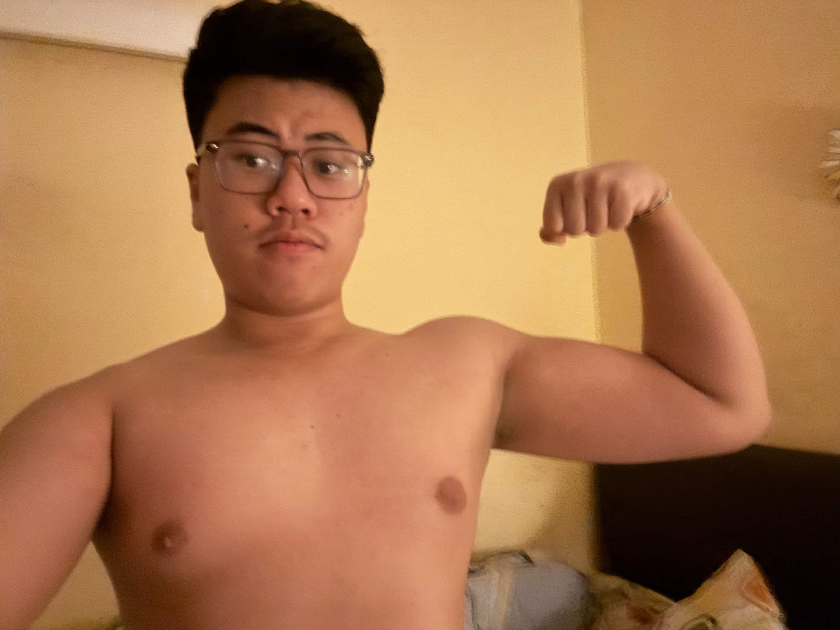 Alvino flexing his arm at home in 2025 after regaining weight